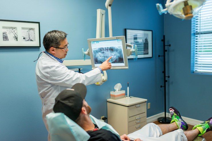 Sugar Land TX Dentist Presenting Dental X-ray Image to Patient