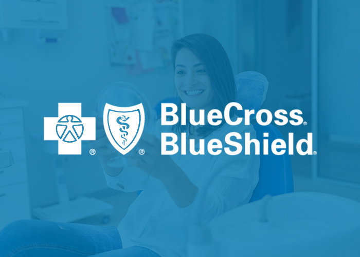 BlueCross BlueShield logo displayed over image of dental professional in clinical office setting.