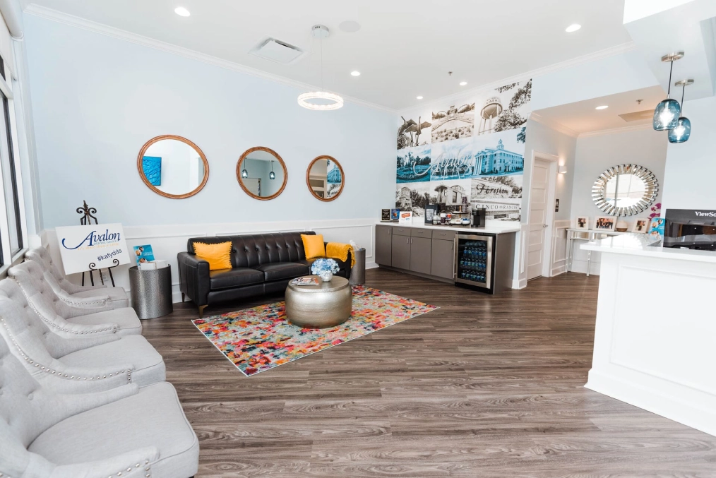 Modern dental office reception area with comfortable seating, contemporary décor, and professional dental equipment.