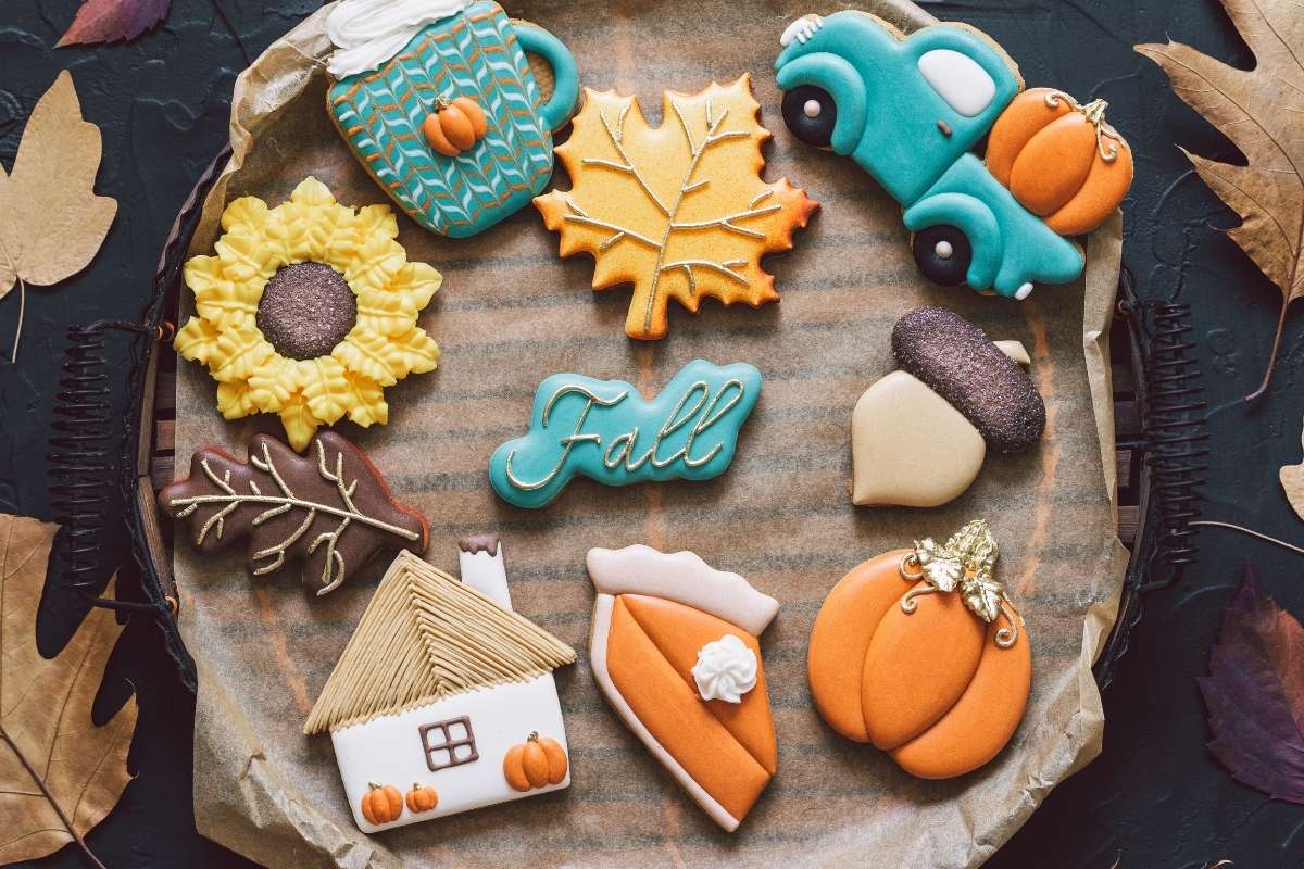 A collection of colorful fall-themed decorated sugar cookies