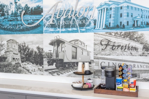 Avalon Dental Group vintage postcards and dental products displayed on white shelf.