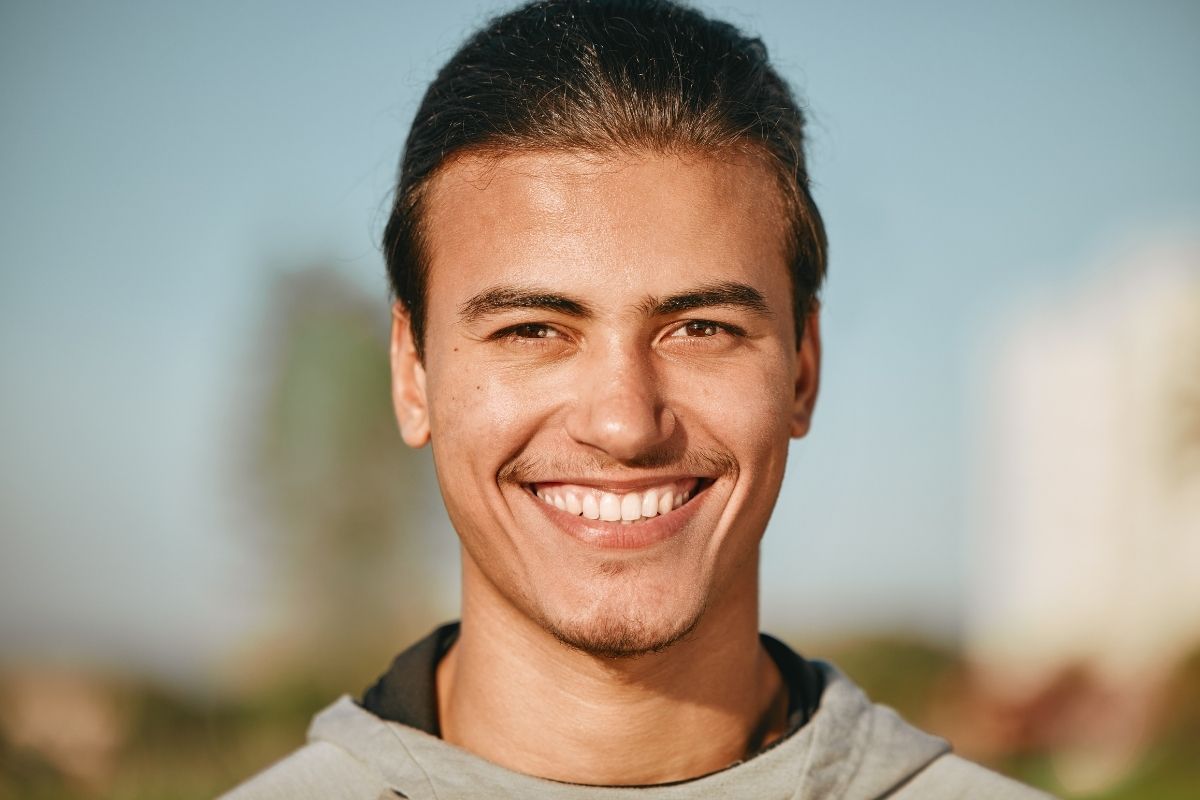 adult man with a beautiful smile showing smile enhancement through cosmetic dentistry