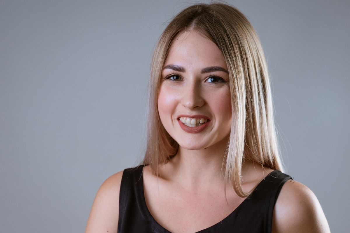 women with uneven teeth smiling