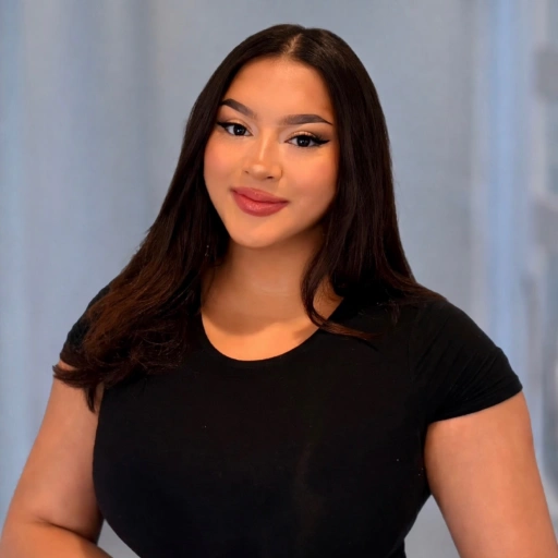 Young woman wearing black t-shirt smiling at camera against blue background