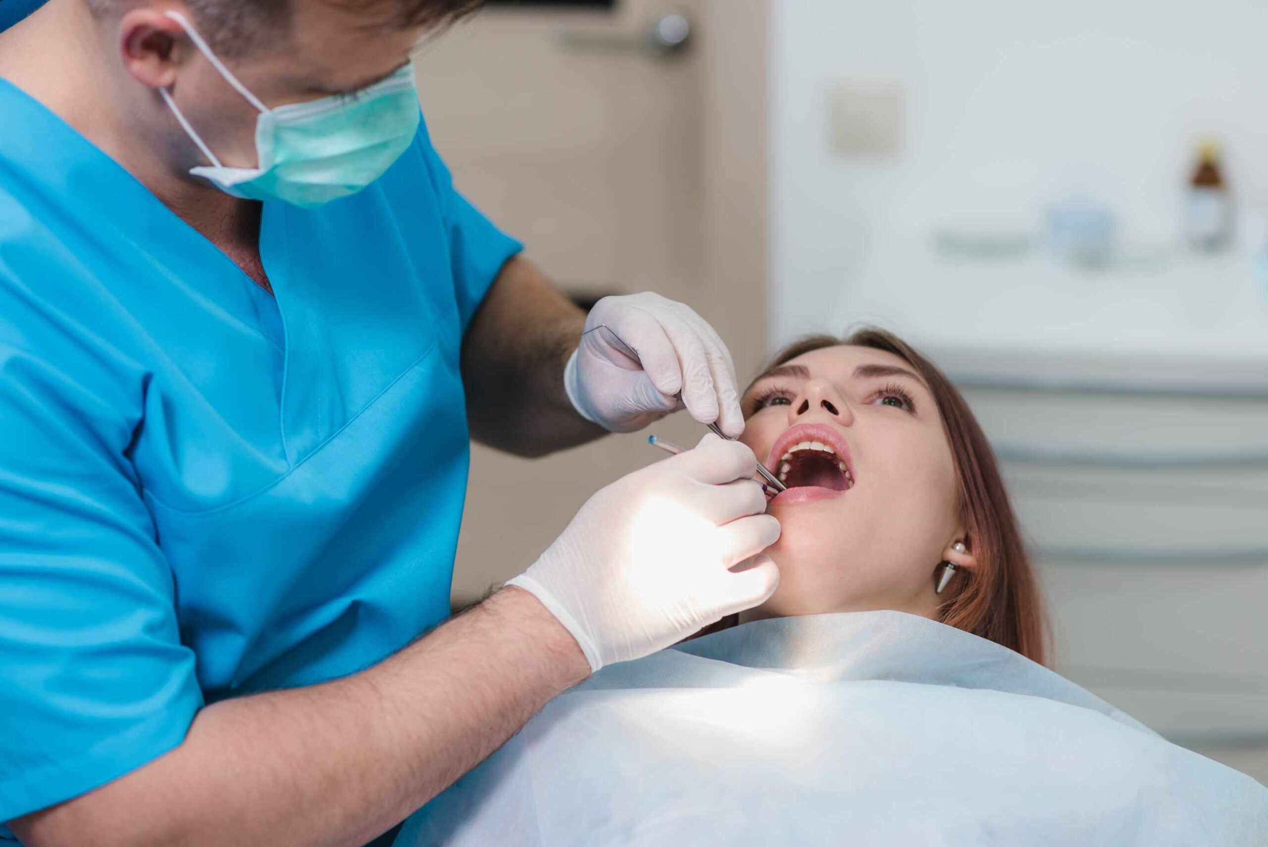 Dentist examining a patient during a routine dental checkup in a clinic